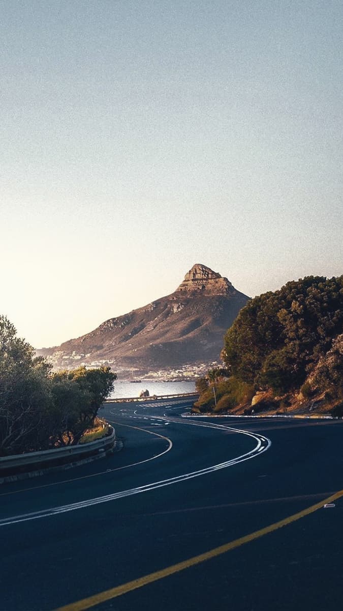 Coastal road curving beneath Lion's Head